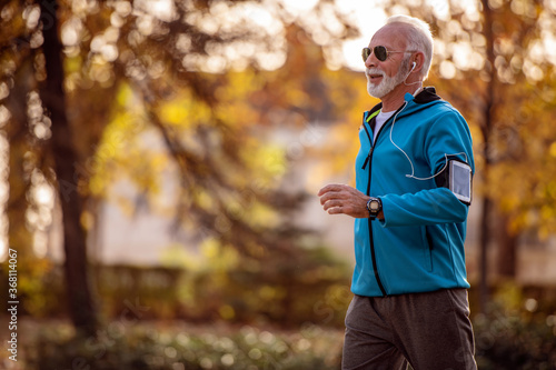 Senior man jogging outdoors.