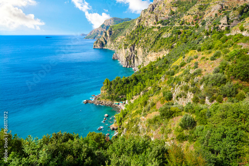 A view from the famous Amalfi Coast drive road towards the cliffs, mountains, coastline, beaches and Mediterranean Sea near the town of Sorrento, Italy photo