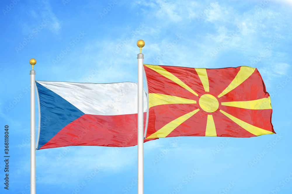 Fototapeta premium Czech and North Macedonia two flags on flagpoles and blue cloudy sky