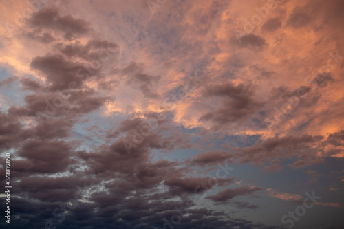 Pink sunset after rain. Black, thunderclouds and blue sky. Sunset at the sea. Summer. Georgia.