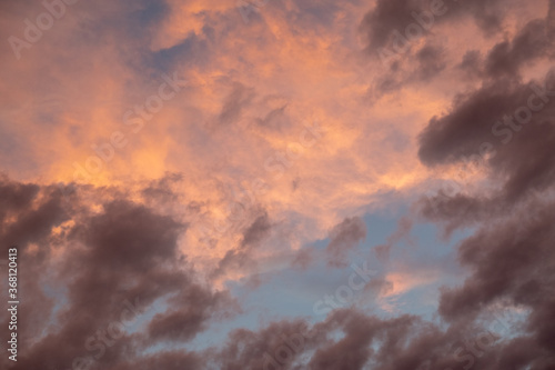 Pink sunset after rain. Black, thunderclouds and blue sky. Sunset at the sea. Summer. Georgia.