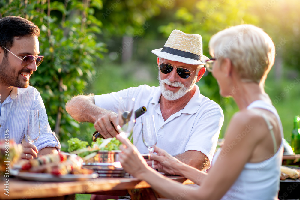 Family having lunch at summer garden party. Family having lunch at summer garden party.