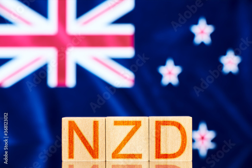 nzd concept. wooden blocks with the inscription nzd on background Flag of New Zealand photo