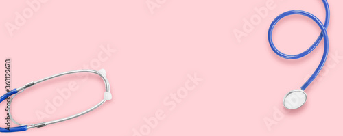 Flat lay. Blue medical stethoscope on pink background. Idea for accessories healthcare & medical. © banphote