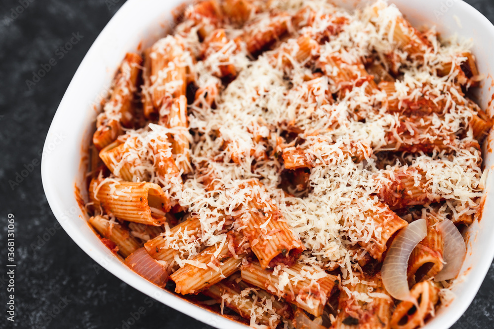 plant-based food, vegan rigatoni pasta bake with red pesto sauce and dairy free cheese before going in the oven plant-based food, vegan rigatoni pasta bake with red pesto sauce and dairy free cheese before going in the oven