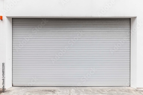 Automatic white roller shutter doors on the ground floor of the house
