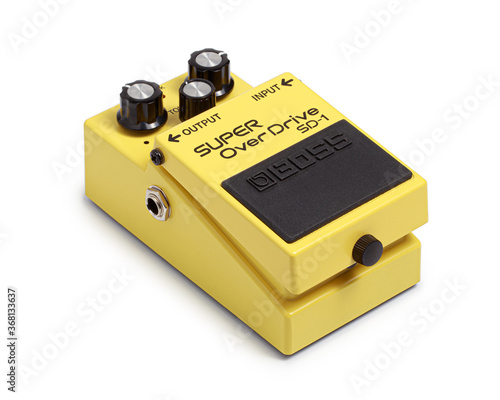 Bangkok, Thailand - July 15, 2020: Boss electric guitar effects pedals  model super overdrive SD-1. Stomp box electric guitar signal over drive yellow effects foot pedal isolated on white background.