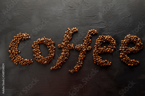 coffee word lined with coffee beans on a dark background