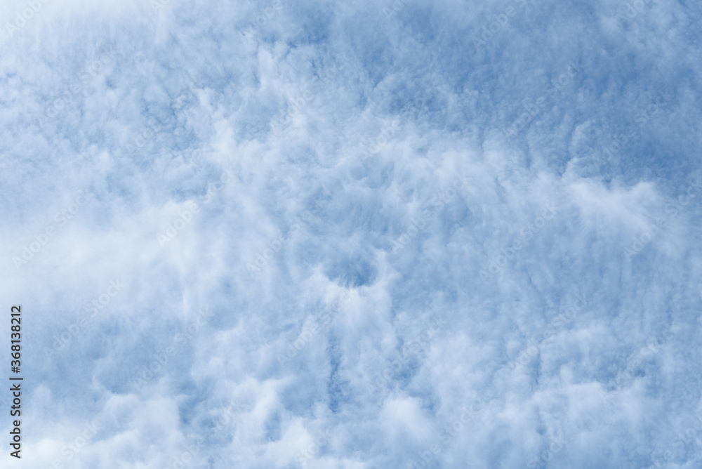 Blue sky and thin striped white cloud layer as a nature background
Blue sky and thin striped white cloud layer as a nature background