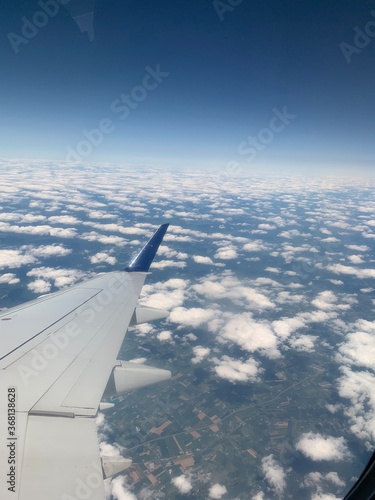 Looking over the clouds under daylight in airplane