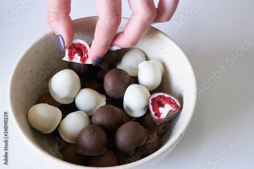 fresh red and shiny fresh raspberries dipped in homemade black and white chocolate