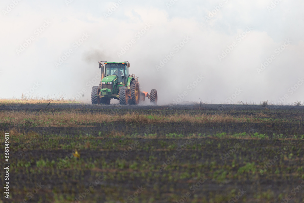 Fototapeta premium truck putting fire down on crop field