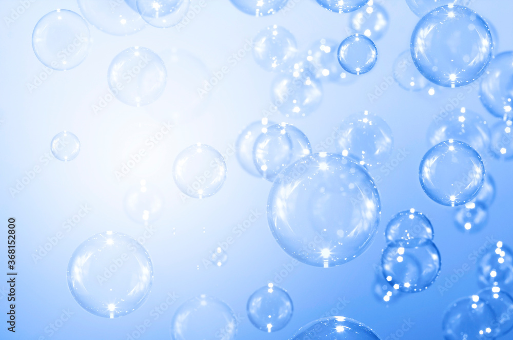 Beautiful blurry clear blue soap bubbles float background 