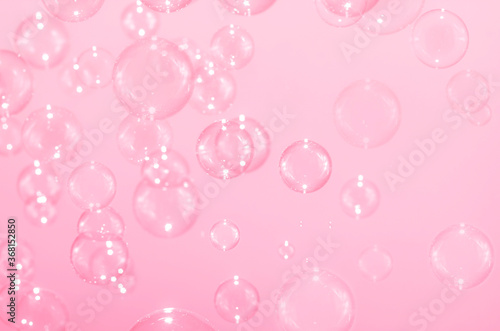 Beautiful blurry clear pink soap bubbles float background 