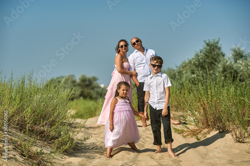 Family portrait in nature . Children and parents in smart clothes on a summer walk