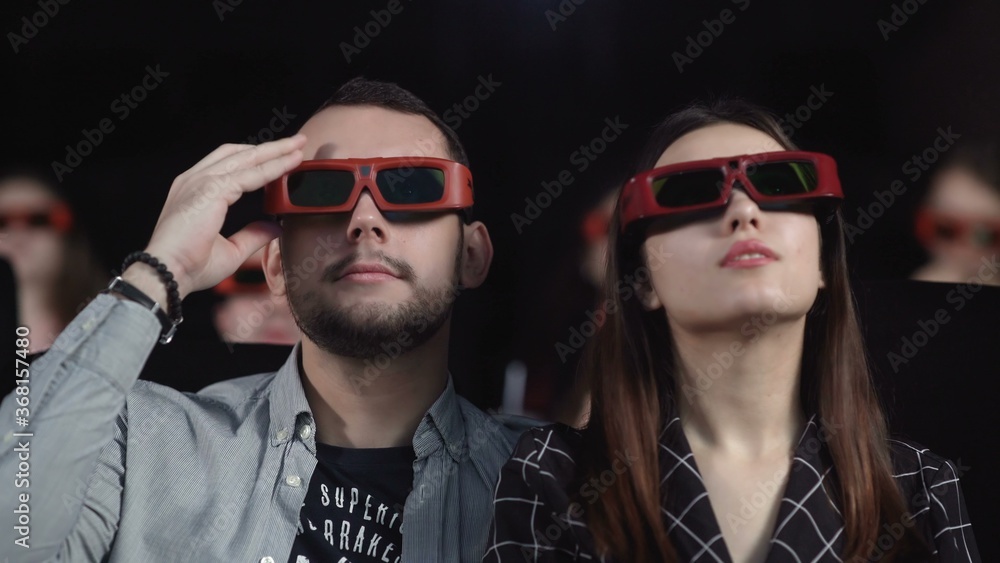 Couple in 3D glasses waching a movie at cinema Couple in 3D glasses waching a movie at cinema