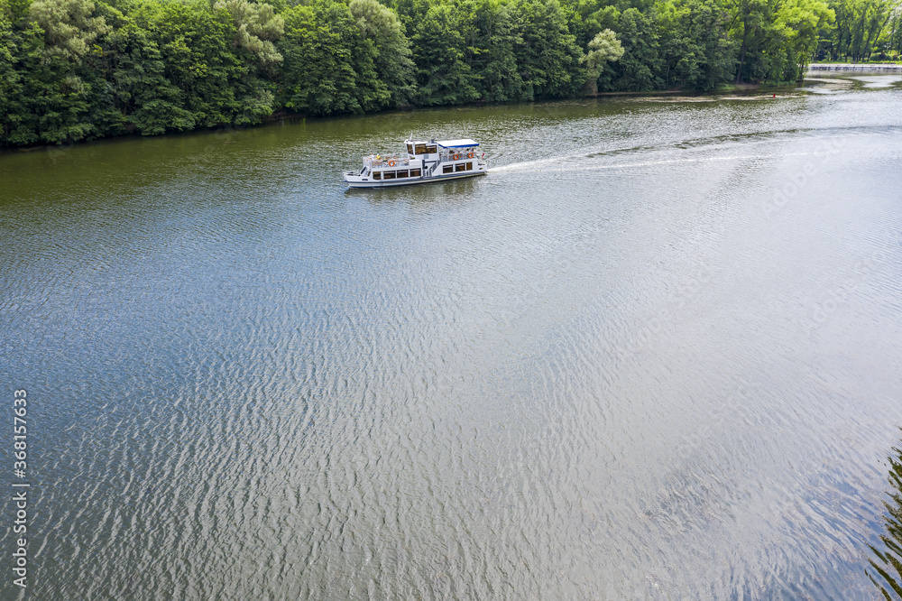 drone aerial view of small cruise ship on the river Svisloch in a summer day