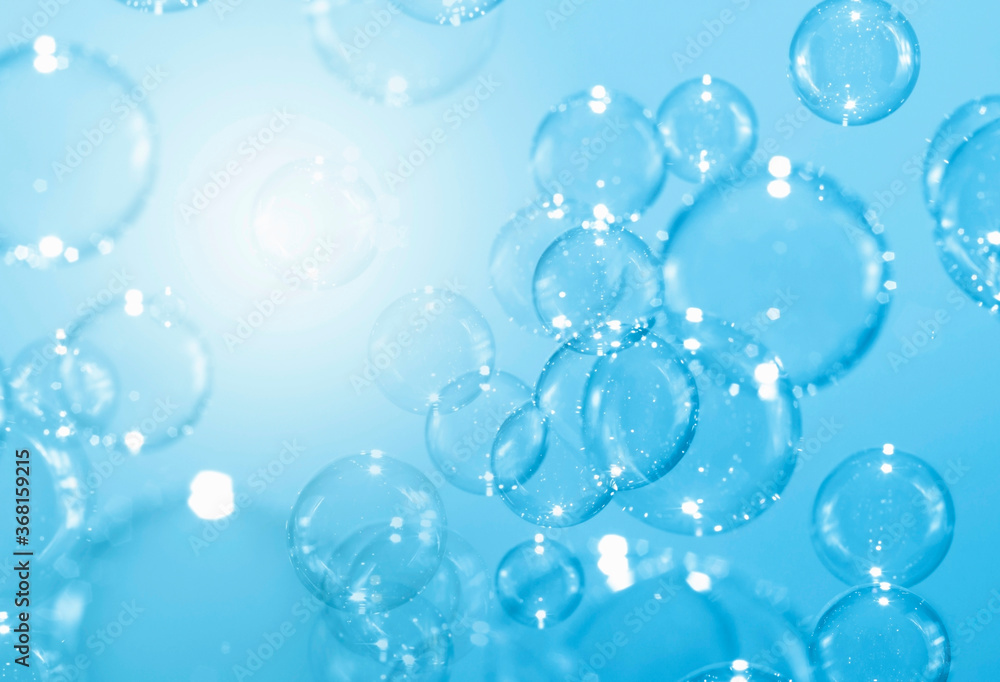 Beautiful blurry clear blue soap bubbles float background Beautiful blurry clear blue soap bubbles float background