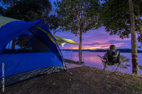 Asian woman enjoy travel looking at view the lake with tent at camping at twilight  © Lab_Photo