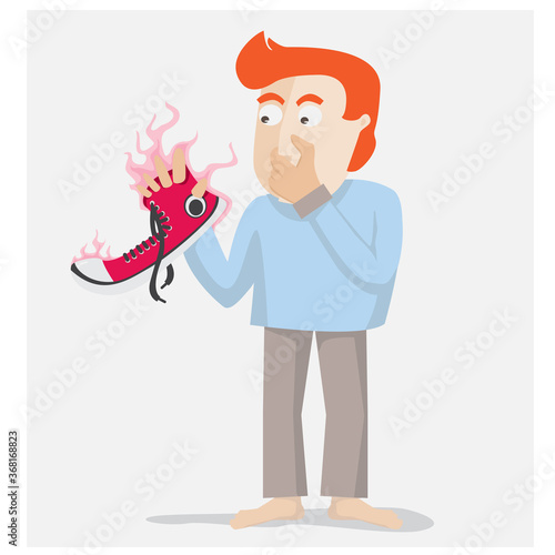 young man holding his shoe and close his nose because his shoe smell