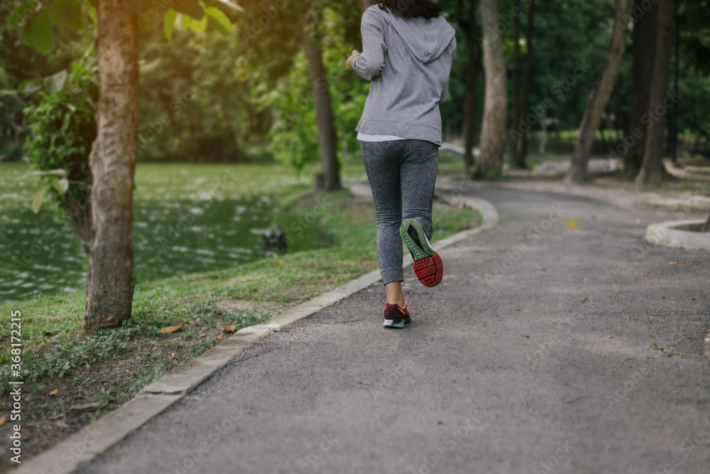 Behind young woman jogging at the park.relax concept. Behind young woman jogging at the park.relax concept.