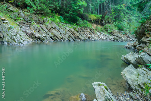 emerald river in a mountain canyon, outdoor travel background