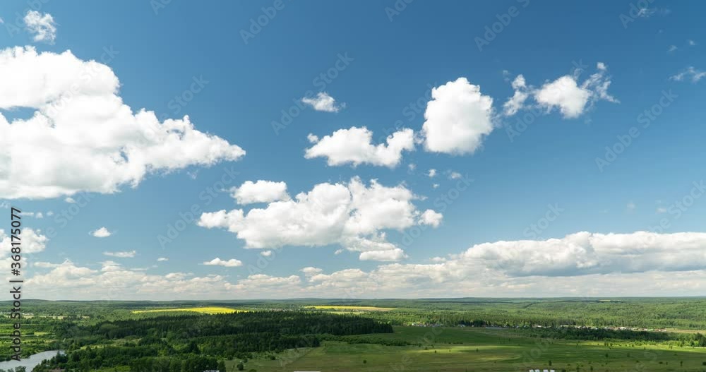 Beautiful cloudy landscape in summer time lapse. Blue sky with clouds 4K. Wonderful summer weather. The sun shines through the clouds. Clouds are floating in the sky. Loop. Beautiful cloudy landscape in summer time lapse. Blue sky with clouds 4K. Wonderful summer weather. The sun shines through the clouds. Clouds are floating in the sky. Loop.