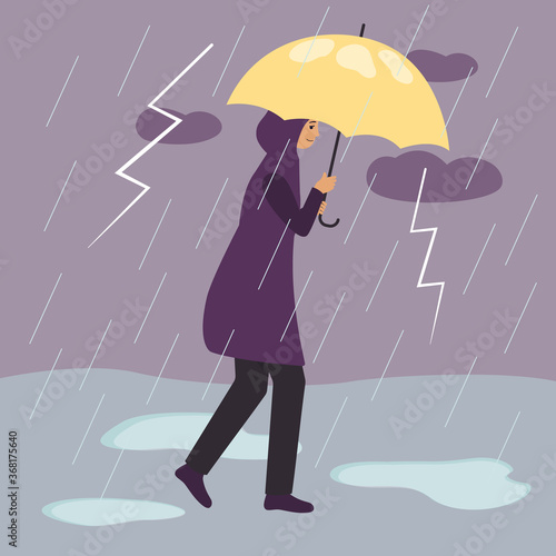 A woman in a raincoat walks under a yellow umbrella during a thunderstorm and rain with lightning.