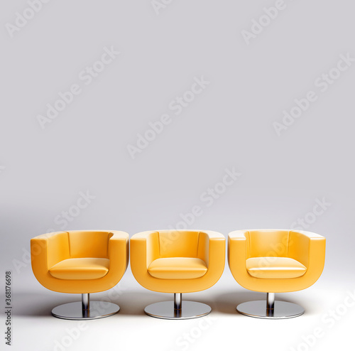Three yellow leather armchairs