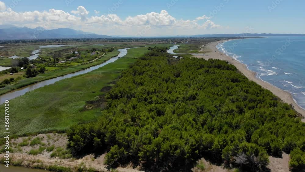Beautiful seaside in Albanian coastline of Adriatic with natural lagoon and pine trees near sandy beach Beautiful seaside in Albanian coastline of Adriatic with natural lagoon and pine trees near sandy beach