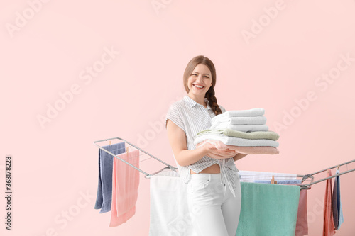 Woman hanging clean towels ...