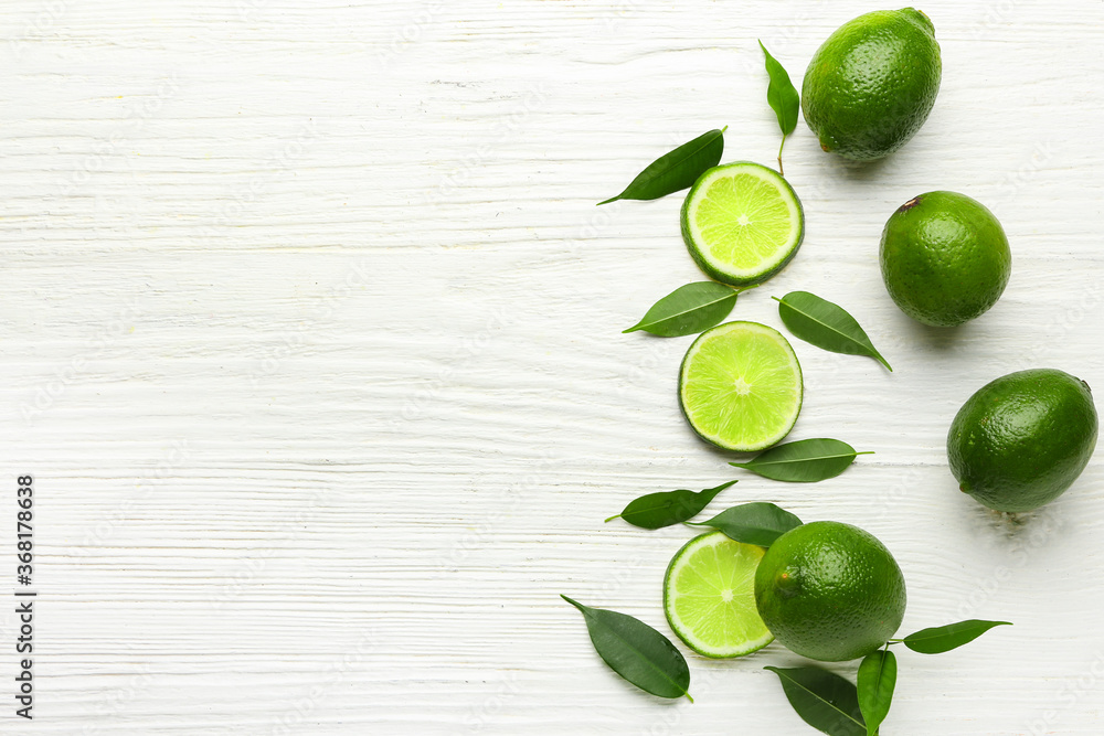 Ripe limes on white wooden background Ripe limes on white wooden background