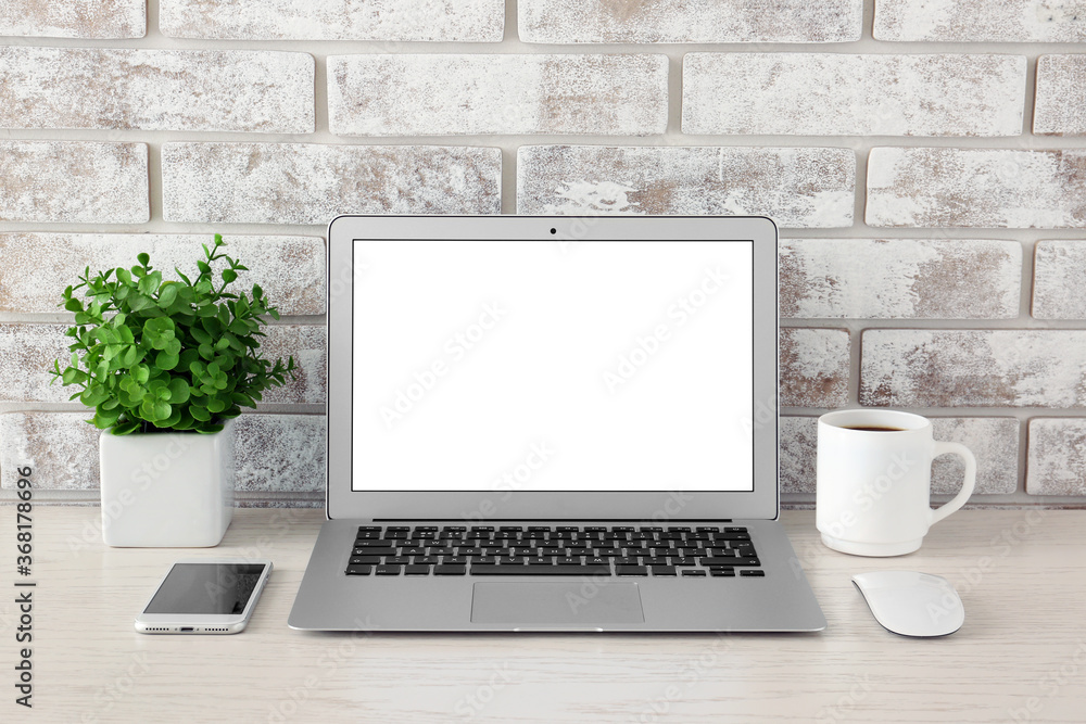 Modern laptop on table in room Modern laptop on table in room