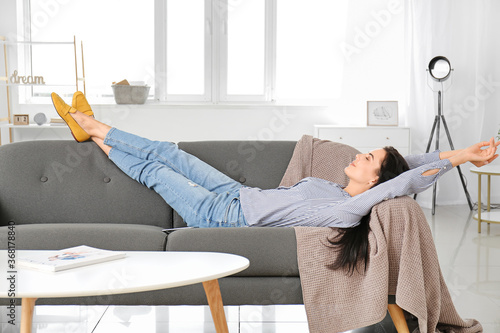 Young woman relaxing on sof...