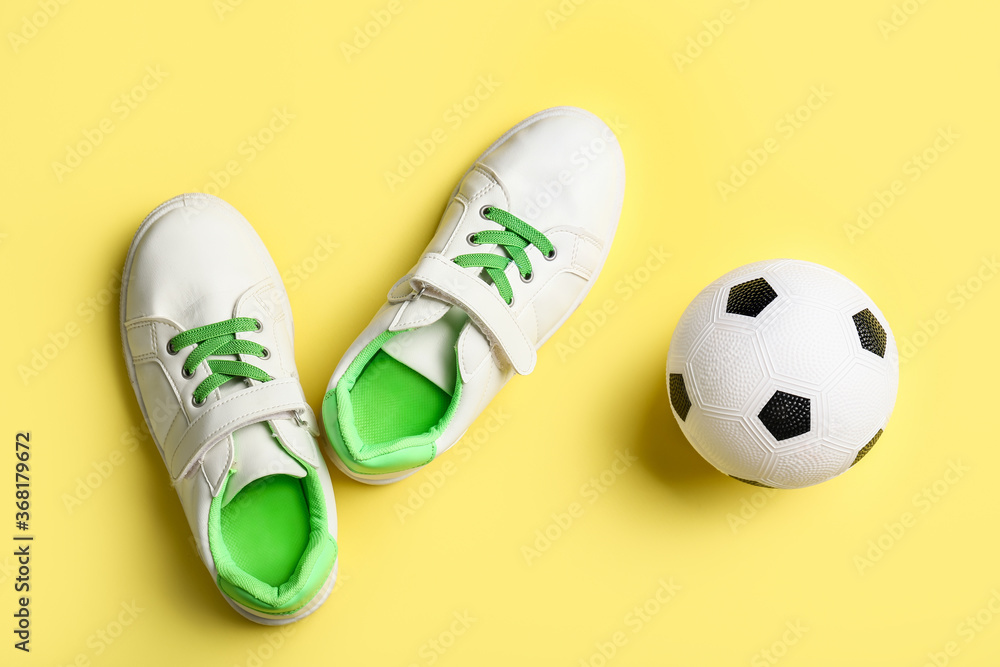Soccer ball and shoes on color background Soccer ball and shoes on color background