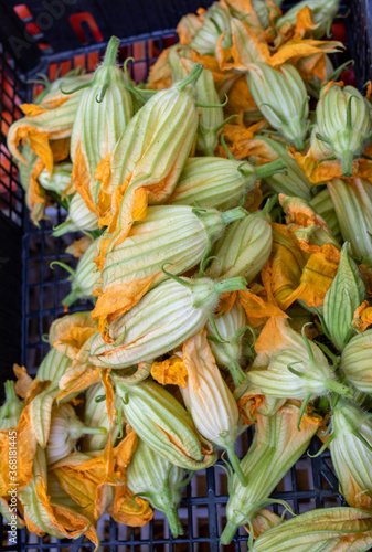 Fresh zucchini flowers at a farmers market in Italy