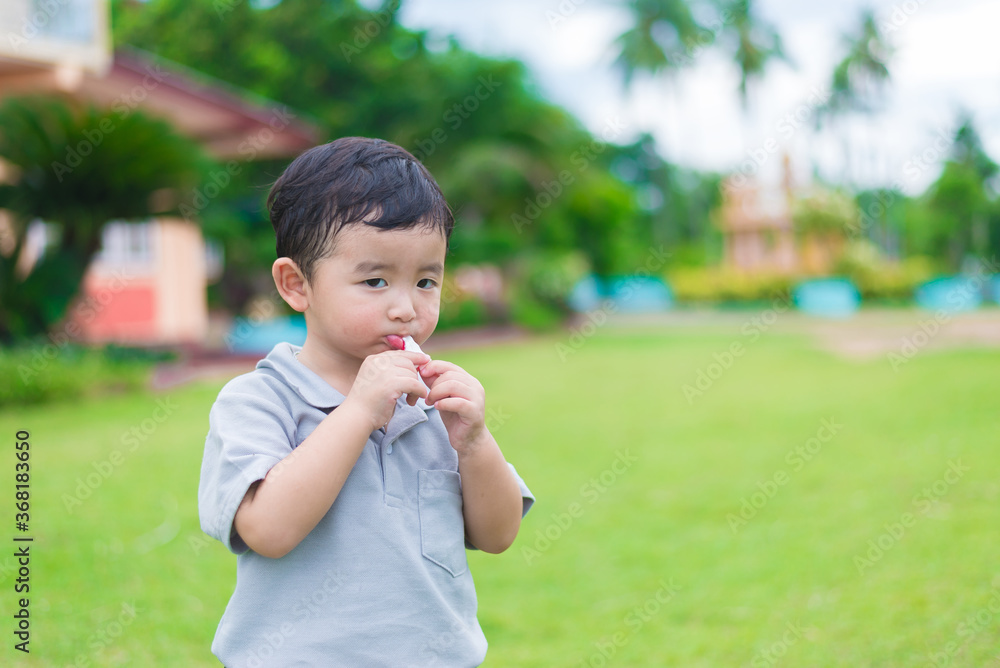 Little Asian kid at the playground under the sunlight, shallow DOF Little Asian kid at the playground under the sunlight, shallow DOF
