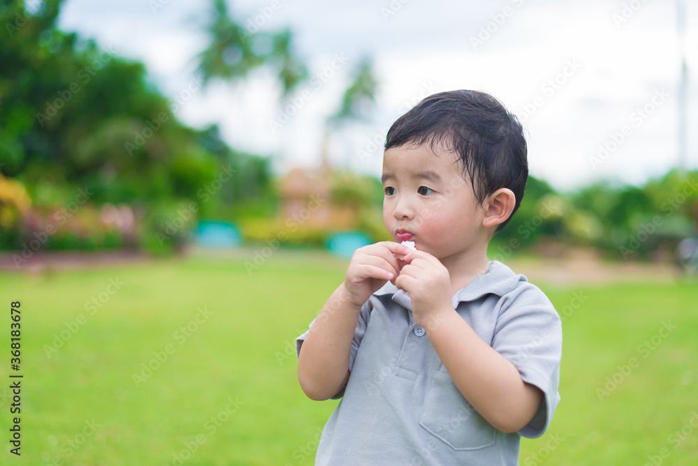 Little Asian kid at the playground under the sunlight, shallow DOF Little Asian kid at the playground under the sunlight, shallow DOF