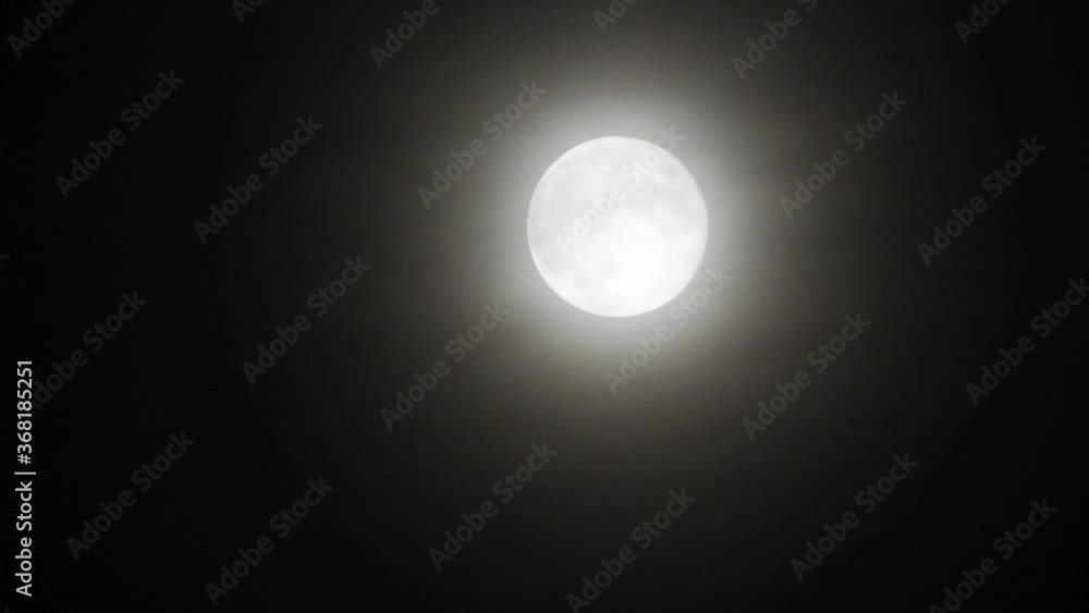 Moon with clouds at night. Spooky scene with full moon and clouds on a dark night Moon with clouds at night. Spooky scene with full moon and clouds on a dark night