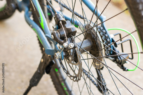 a bicycle rear wheel chain sprocket spokes disc brakes closeup