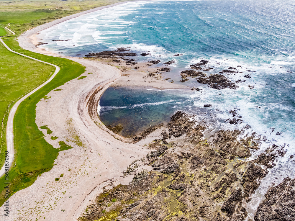 Fototapeta premium Aerial view of the beautiful coast next to Carrickabraghy Castle - Isle of Doagh, Inishowen, County Donegal - Ireland