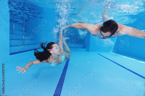 - Cute couple having fun underwater