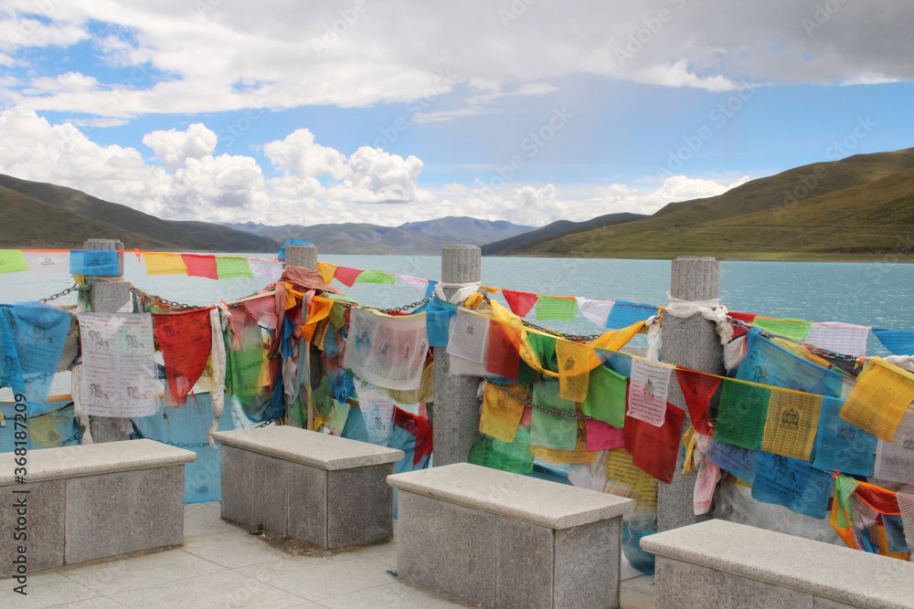 View of Yamdrok Lake with the prayer flags in a sunny day, Tibet, China