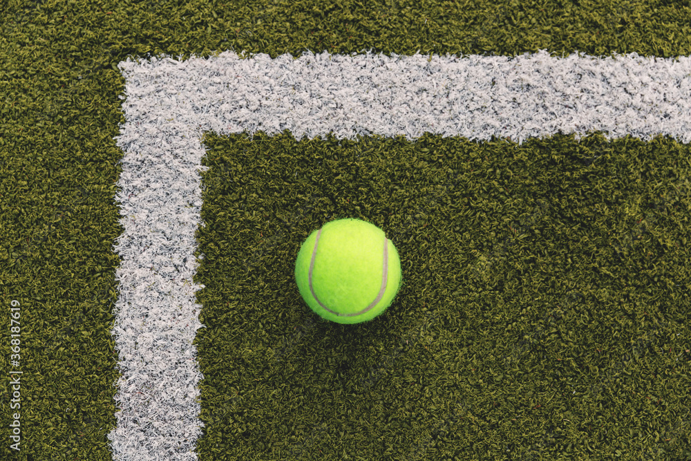 Yellow tennis ball on the tennis court.