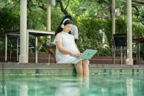 young pregnant woman relaxing in a swimming pool