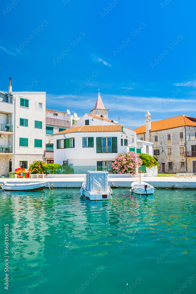 Croatia, Adriatic coastline, coastal town of Pirovac, waterfront view of old buildings and boats in harbour