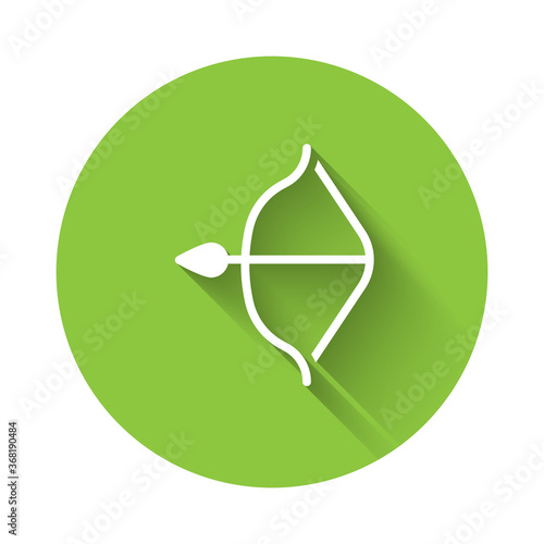 White Medieval bow and arrow icon isolated with long shadow. Medieval weapon. Green circle button. Vector.