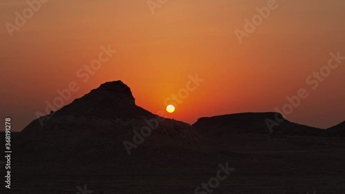 Wallpaper Mural Wide shot of the sun during a sunset with silhouetted hills on left and right of the frame. Torontodigital.ca