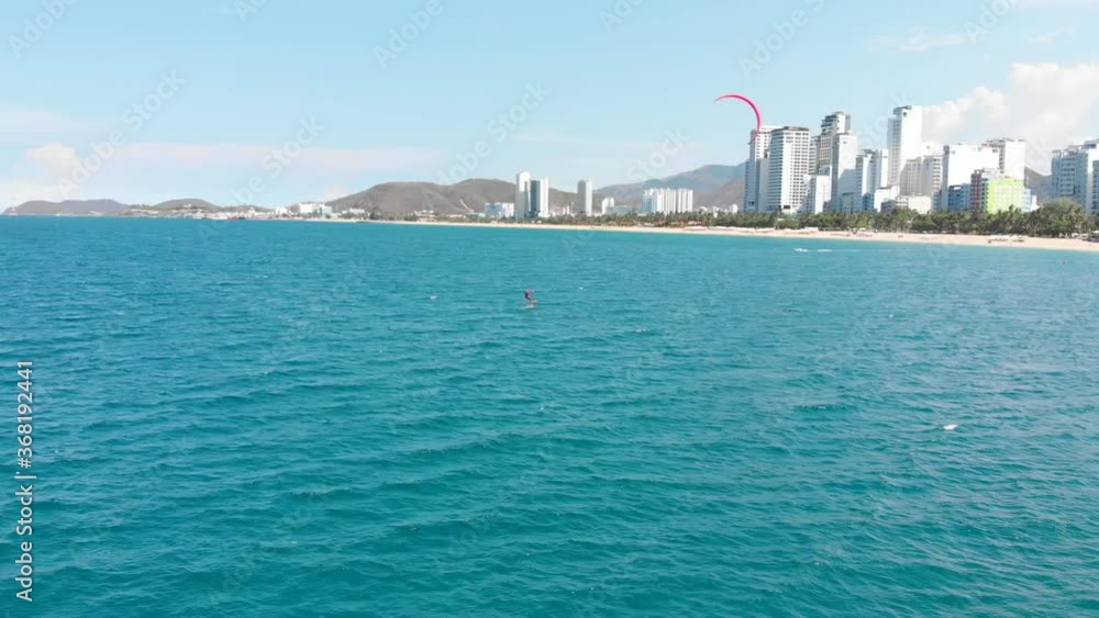 Extreme water sport and summer vacations concept. Professional kite surfer on the sea wave, athlete showing sport trick jumping with kite and board in air. Extreme water sport and summer vacations concept. Professional kite surfer on the sea wave, athlete showing sport trick jumping with kite and board in air.
