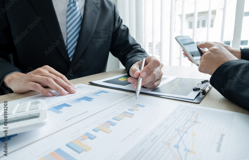 Two business leaders talk about charts, financial graphs showing results are analyzing and calculating planning strategies, business success building processes Two business leaders talk about charts, financial graphs showing results are analyzing and calculating planning strategies, business success building processes